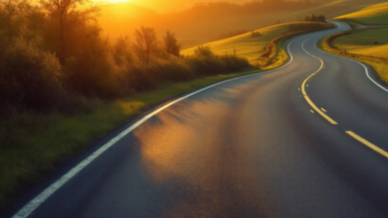 An empty quiet road curving through autumn-free green hills at sunrise, the FenderWise view of car repair loans online, $100 – $5,000